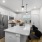 kitchen and living area with an island and bright, natural lighting