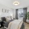 Bedroom with queen bed and large window