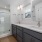 bathroom with a large mirror and ample lighting