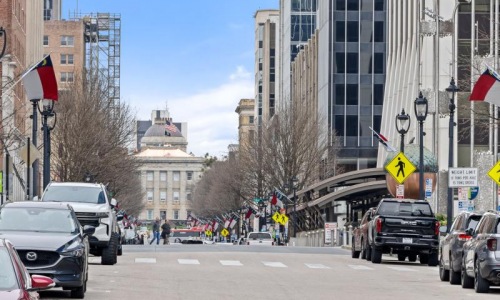 a busy street with cars and people