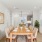 Large dining room table with chairs leading into the kitchen