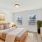 Large bedroom with queen bed and windows