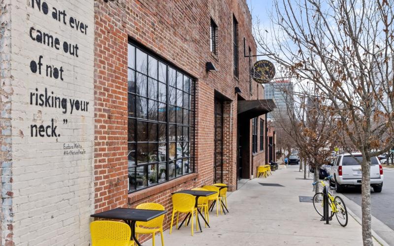 a brick building with tables and chairs